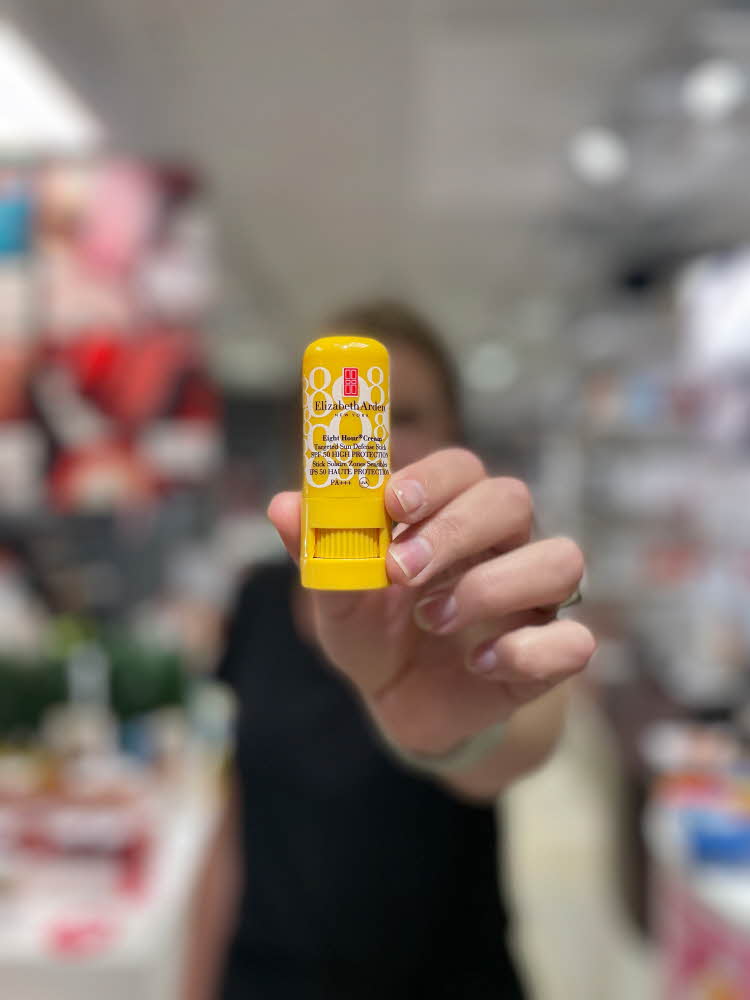 Dame som holder lip balm med solfaktor