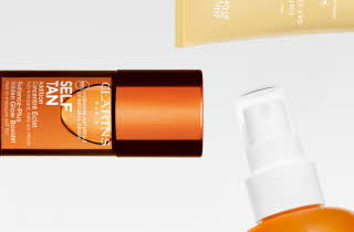 En oransje self tan flaske og spray tuten til en Biotherm solkrem flaske.