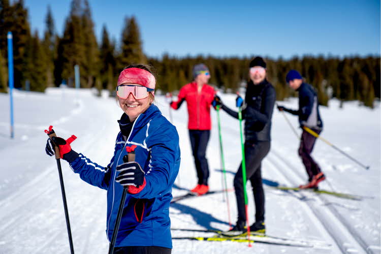 Jente som går på ski med venner