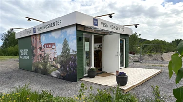 Bilde av fasaden til visningssenteret til boligprosjektet Heggedal Hage.