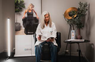 dame med hvit frakk som sitter i en stol