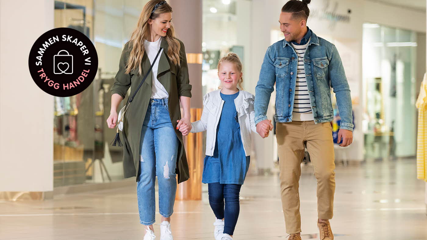 Familie på 3 går hånd i hånd gjennom senteret, med svart logo "sammen skaper vi trygg handel"