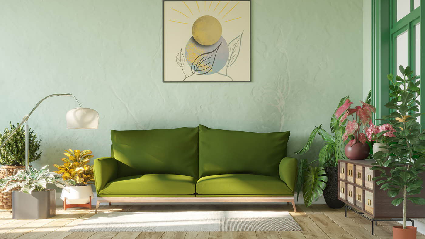 Grønn sofa i en stue med grønne planter