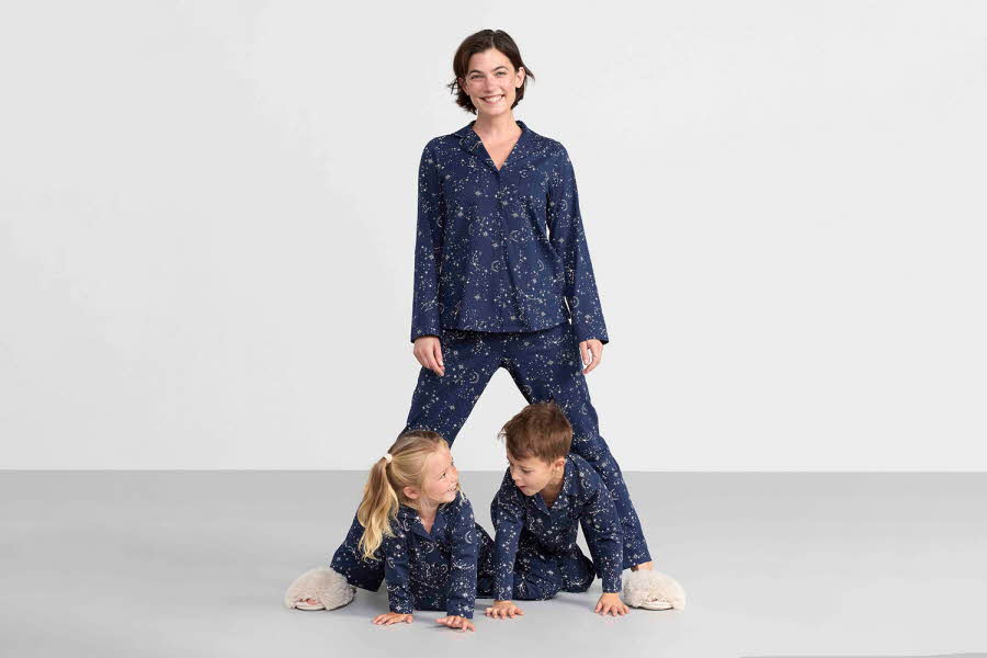 Dame og barn som poserer i blå pyjamas