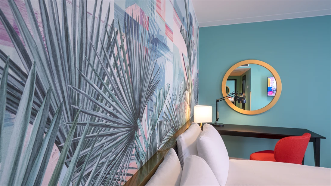 Fargerik palmetapet og dobbeltseng i superior rom på thon Hotel Storo