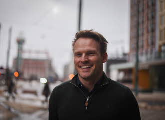 Bilde av Lars Eikeland Hagen i Oslo Sentrum. Han smiler mot kameraet. 