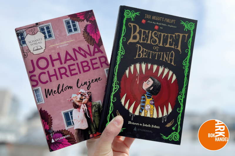 En hånd holder oppe en bok som heter "Mellom linjene" og en bok som heter "Beistet og Bettina"
