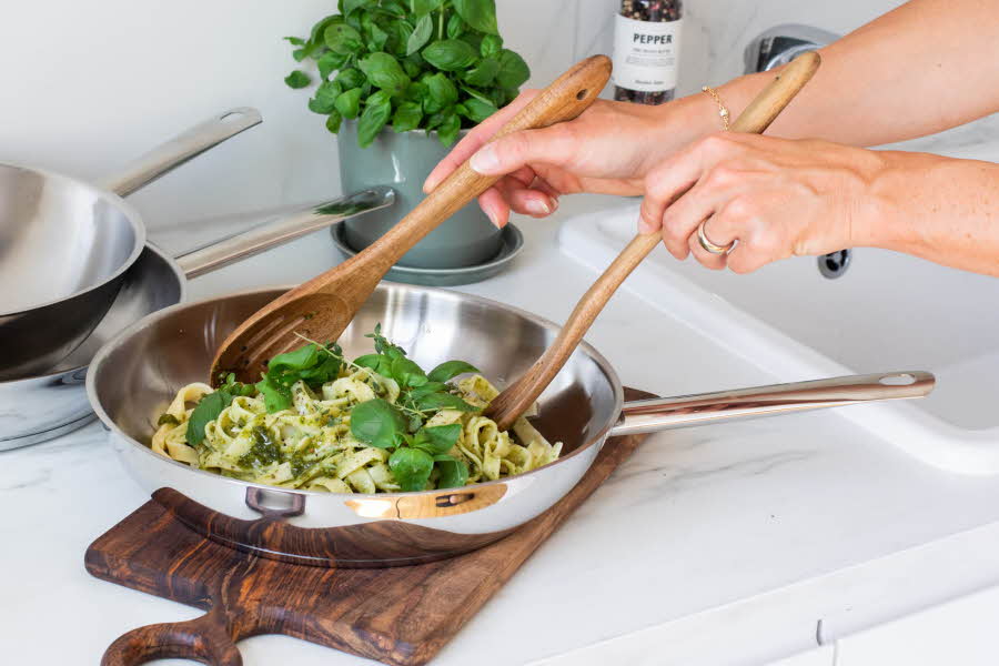En sølvfarget stekepanne med pasta