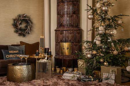 stue dekorert i juletema med juletre, pynteputer, julegaver, stearinlys