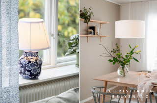 En bordlampe ved et vindu og en spisestue med et trebord.