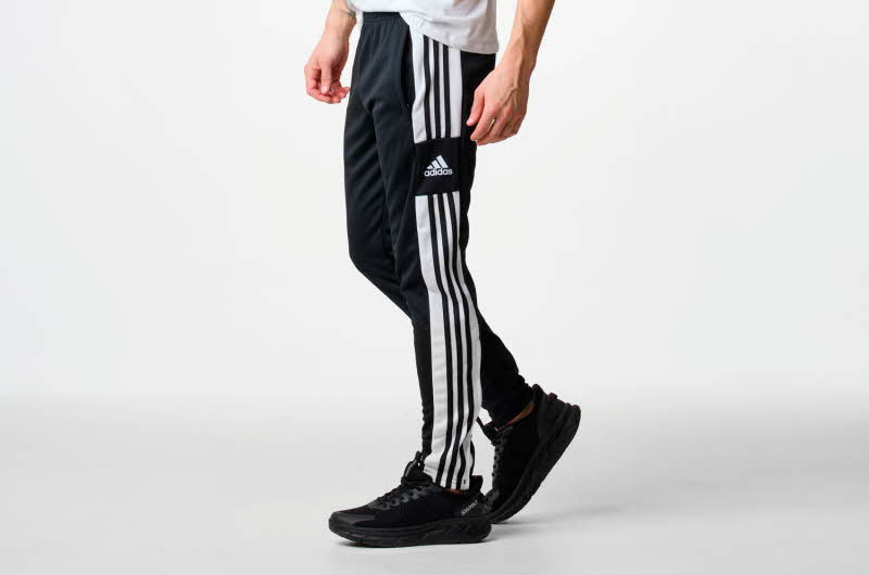 Mann med svart Adidas treningsbukse og sko