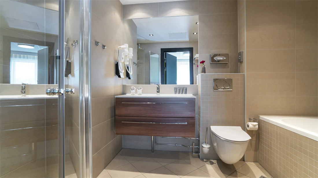 Bad på en av suitene med badekar, toalett, stor dusj og vask på Thon Hotel Europa i Oslo sentrum rett ved Slottsparken