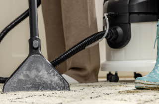 Rengjøringsmaskin som vasker et teppe.