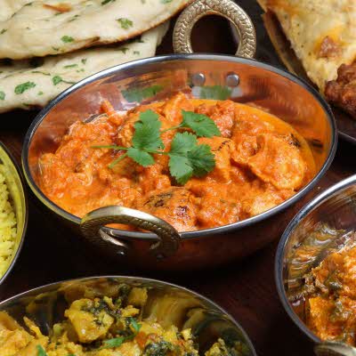 Bord dekket med indiske matretter med kylling og nan