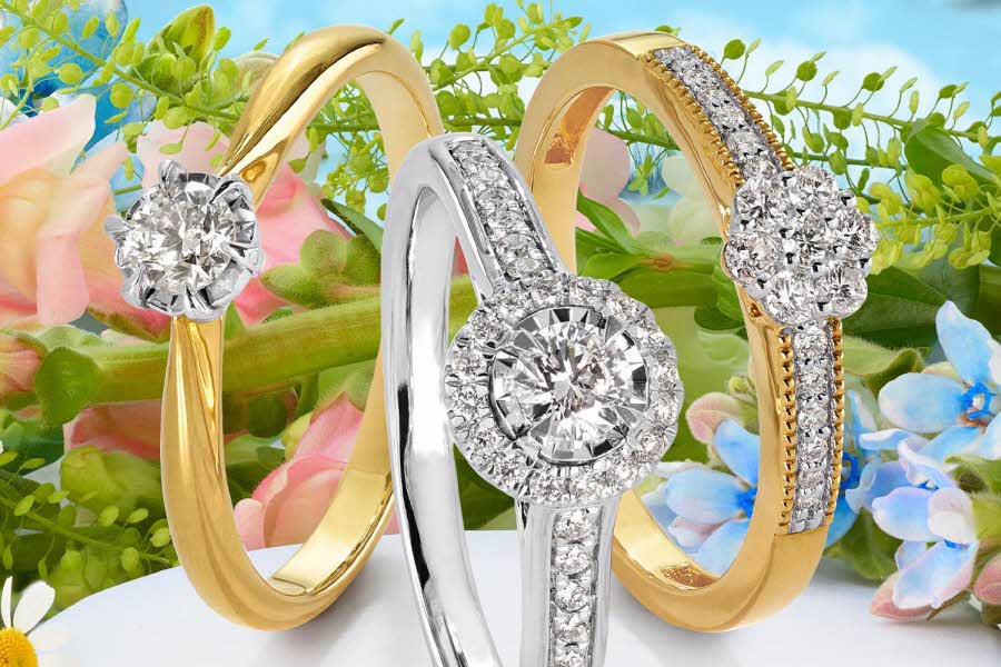 tre diamantring med vårlig og blomstrete bakgrunn