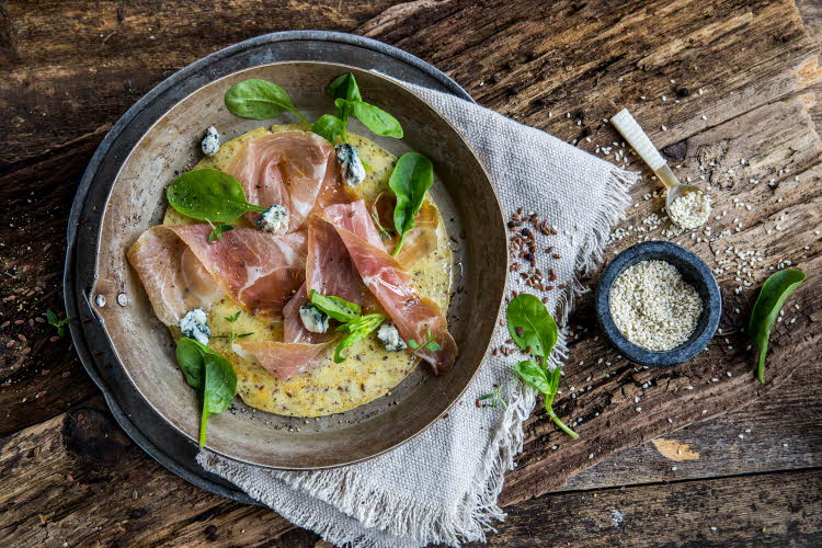 Tallerken med omelett og serranoskinke med ruccola