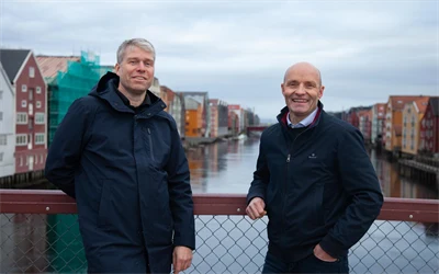 Trond Are Martinsen og Ståle Dullum står på Gamle Bybro med bryggerekka i bakgrunnen. Portrett tatt ifm. oppussing av Kjøpmannsgata 15 i Trondheim.