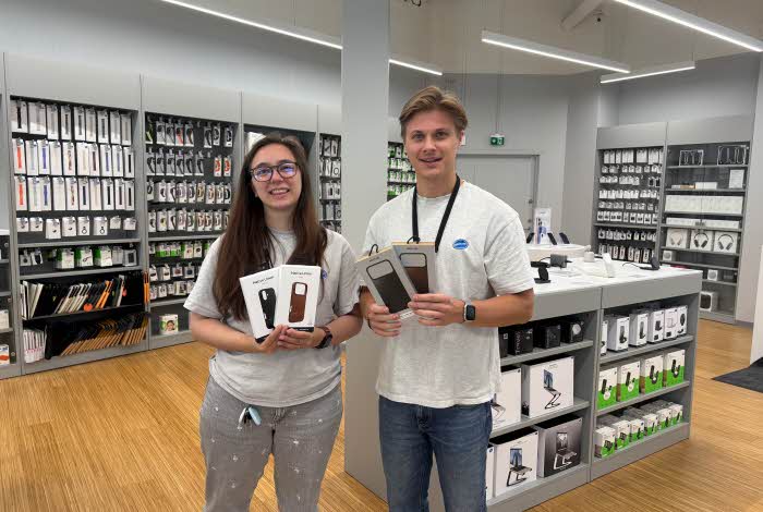 Ansatte fra Eplehuset holder mobildeksler til den nye iPhone 17
