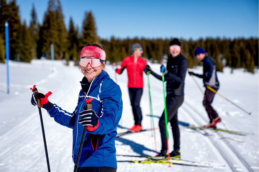 Jente som går på ski med venner
