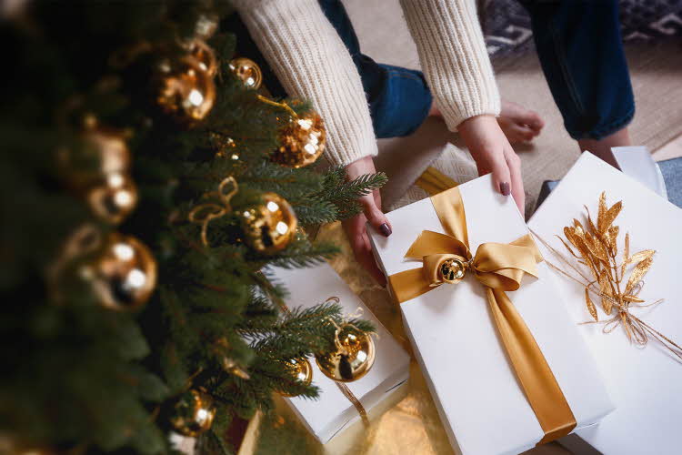 Person henter pakke under juletre