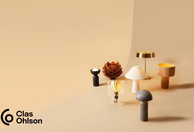 Sju forskjellige bordlamper fra Northlight som står på bakken mot en beige bakgrunn