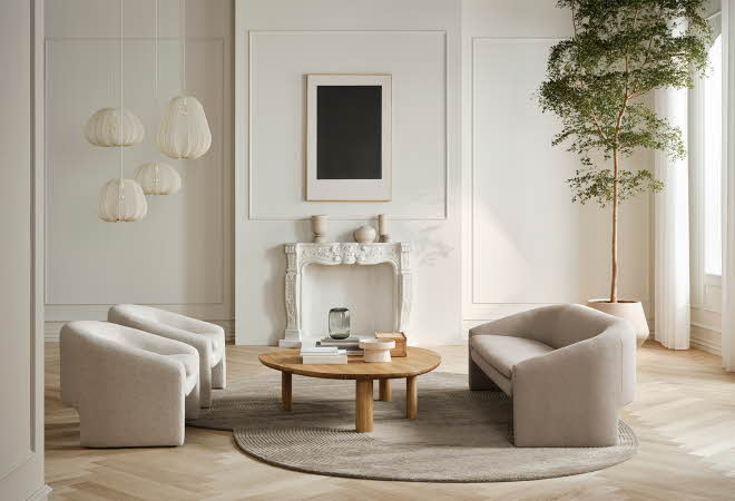 Lys stue med sittegruper,stuebord, teppe, hengende lamper og grønn plante i hjørnet.
