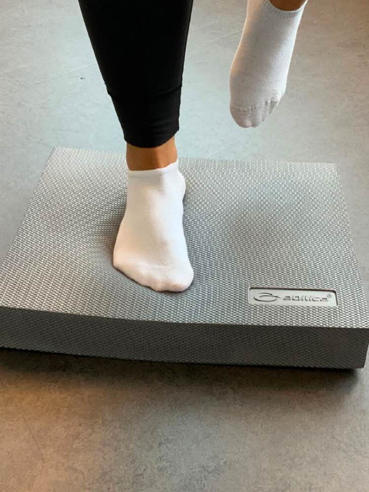 Person står på en balansepute