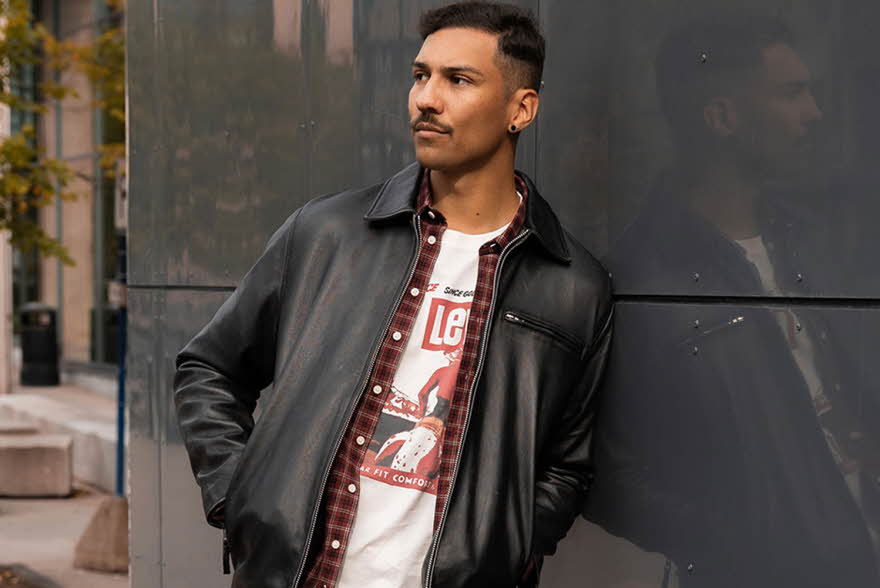 Mann som lener seg på en vegg