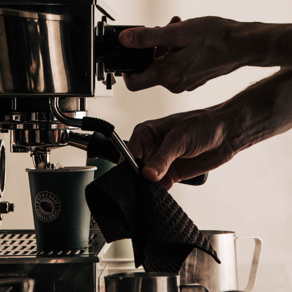 mann som lager kaffe med kaffemaskin