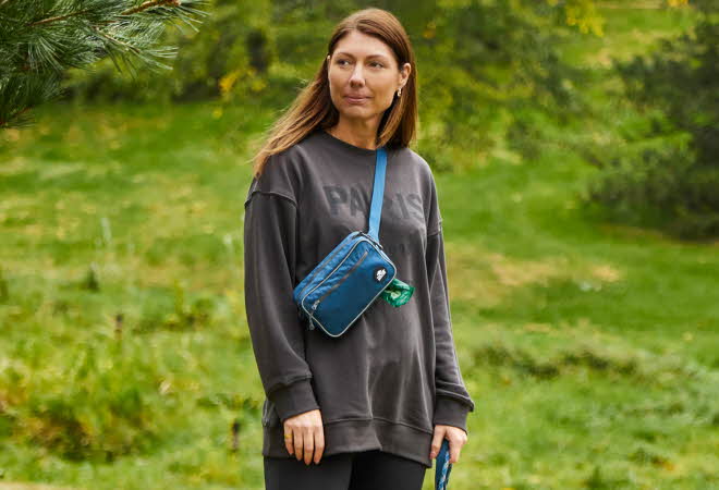 kvinne med bag og grå genser