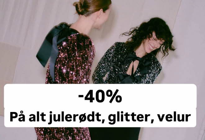 En lyshåret og en mørkhåret dame som har på seg glitterende kjoler